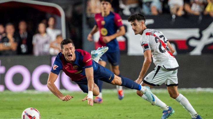 Rayo Vallecano captain Oscar Valentin (right) fouls Robert Lewandowski last month